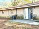 Brick house with a sliding glass door leading to a small patio with chairs at 3615 Leisure Lane, Atlanta, GA 30349