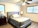 Main bedroom with gray upholstered bed and ceiling fan at 3615 Leisure Lane, Atlanta, GA 30349