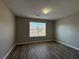 Spacious bedroom with large window and wood-look floors at 7289 Wagon Wheel Ct, Jonesboro, GA 30236