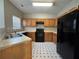 Galley kitchen with wood cabinets and black appliances at 7289 Wagon Wheel Ct, Jonesboro, GA 30236