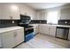 Modern kitchen with stainless steel appliances and hexagon tile backsplash at 1728 Line St, Decatur, GA 30032