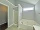 Bathroom boasting a tub, shower, and walk-in closet at 2897 Hutchins Walk Ct, Snellville, GA 30078