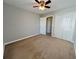 Bedroom with carpet, ceiling fan, and double doors at 2897 Hutchins Walk Ct, Snellville, GA 30078