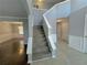 Two-story foyer with a grand staircase and tile flooring at 2897 Hutchins Walk Ct, Snellville, GA 30078