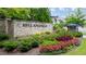 Stone community entrance sign with colorful landscaping welcomes residents and visitors at 1010 Coleman Place Dr, Roswell, GA 30075