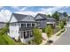 Exterior view of homes with white brick, black shutters, and dark metal roofs at 1010 Coleman Place Dr, Roswell, GA 30075