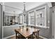 Small dining area with wooden table and mirrored accent wall at 1072 Piedmont Ne Ave # 108, Atlanta, GA 30309