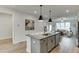 Modern kitchen with gray island and white cabinets at 1280 Ainsworth Aly # 53, Sugar Hill, GA 30518