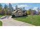 Gray house with a large driveway and a well-manicured lawn at 320 Discovery Lake Dr, Fayetteville, GA 30215