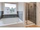 Bathroom featuring a soaking tub and a walk-in shower at 75 Barge Ln, Covington, GA 30016