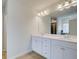 Double vanity bathroom with white cabinets and a large mirror at 75 Barge Ln, Covington, GA 30016