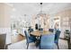 Bright dining area with a round table, blue chairs, and views into the kitchen at 217 Bluestone Dr, Woodstock, GA 30188