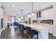 Modern kitchen with white cabinets, large island, and stainless steel appliances at 217 Bluestone Dr, Woodstock, GA 30188