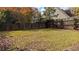 Fenced backyard with grassy area and mature trees at 405 Northwind Pl, Stockbridge, GA 30281