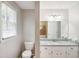 Bathroom with granite countertop, toilet and white cabinets at 543 Banks Rd, Fayetteville, GA 30214