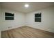 Well-lit bedroom featuring light wood flooring and two windows at 851 Flagler Cir, Smyrna, GA 30080