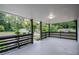 Spacious covered porch with modern railing, offering views of the street and neighborhood at 851 Flagler Cir, Smyrna, GA 30080