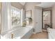 Elegant bathroom with soaking tub and stained-glass window at 992 Bridgegate Ne Dr, Marietta, GA 30068