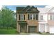 Brick two-story townhome with a two-car garage and landscaping at 265 Dupont Dr # 33, Cartersville, GA 30121