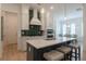 Modern kitchen with white cabinets, green tile backsplash, and island at 724 Fairlane Dr, Marietta, GA 30064