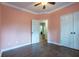 Peach bedroom with hardwood floors and access to other rooms at 123 Wildwood Dr, Temple, GA 30179