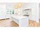 Modern kitchen with white cabinetry, marble counters, and a large island at 2624 Forrest Ne Way, Atlanta, GA 30305