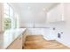 Bright laundry room with white cabinets and marble counters at 2624 Forrest Ne Way, Atlanta, GA 30305