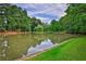 Serene pond with lush trees and landscaping at 2624 Forrest Ne Way, Atlanta, GA 30305