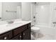 Clean bathroom with dark vanity, shower/tub combo, and white toilet at 417 Crimson Maple Way, Smyrna, GA 30082