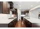 Modern kitchen with dark cabinetry, granite countertops, and stainless steel appliances at 417 Crimson Maple Way, Smyrna, GA 30082