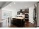 Modern kitchen with island, stainless steel appliances, and hardwood floors at 417 Crimson Maple Way, Smyrna, GA 30082