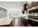 Modern kitchen with dark cabinetry, granite countertops and stainless steel appliances at 417 Crimson Maple Way, Smyrna, GA 30082