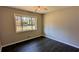 Bright bedroom with large window, ceiling fan, and dark laminate floors at 3146 Vandiver Dr, Marietta, GA 30066