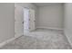 Spacious basement bedroom with gray carpet and double doors at 5732 Cypress Bluff Ln, Hoschton, GA 30548