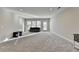 Spacious finished basement with neutral walls and plush carpeting at 5732 Cypress Bluff Ln, Hoschton, GA 30548
