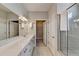 Modern bathroom with double vanity, large mirror and a walk-in shower at 5732 Cypress Bluff Ln, Hoschton, GA 30548