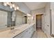 Modern bathroom with double vanity, large mirror and a walk-in shower at 5732 Cypress Bluff Ln, Hoschton, GA 30548