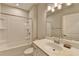Clean bathroom with a bathtub, sink, and modern vanity at 5732 Cypress Bluff Ln, Hoschton, GA 30548