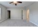 Well-lit bedroom featuring gray carpeting and an ensuite bathroom at 5732 Cypress Bluff Ln, Hoschton, GA 30548