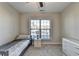 Bright bedroom with a twin bed and large window at 5732 Cypress Bluff Ln, Hoschton, GA 30548