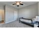 Spacious bedroom with large window and ceiling fan at 5732 Cypress Bluff Ln, Hoschton, GA 30548