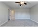 Bedroom with ceiling fan, neutral walls and gray carpet at 5732 Cypress Bluff Ln, Hoschton, GA 30548