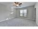 Bright bedroom with ceiling fan and neutral wall colors at 5732 Cypress Bluff Ln, Hoschton, GA 30548