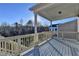 Covered deck with wooden railings, offering scenic views at 5732 Cypress Bluff Ln, Hoschton, GA 30548