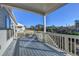 Covered deck with wooden railings, offering scenic views at 5732 Cypress Bluff Ln, Hoschton, GA 30548