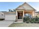 Two-story craftsman style home with brick and siding, landscaped yard, and attached garage at 5732 Cypress Bluff Ln, Hoschton, GA 30548