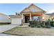 Two-story craftsman style home with brick and siding, landscaped yard, and attached garage at 5732 Cypress Bluff Ln, Hoschton, GA 30548