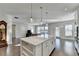 Open concept kitchen with large island and hardwood floors at 5732 Cypress Bluff Ln, Hoschton, GA 30548