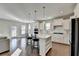 Modern kitchen with white cabinets, island, and stainless steel appliances at 5732 Cypress Bluff Ln, Hoschton, GA 30548