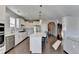 Modern kitchen with white cabinets, island, and stainless steel appliances at 5732 Cypress Bluff Ln, Hoschton, GA 30548